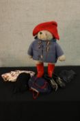 A 20th century Paddington Bear complete with various clothes and a pair of football boots. H.55cm.