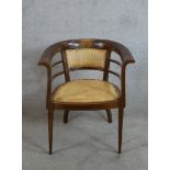 An early 20th century inlaid mahogany framed bow back chair with studded leather seat and back