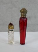 A 19th century tapering ruby glass and brass mounted scent bottle togther with a 19th century cut