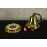 A brass ships style bell, together with a beech framed circular aneroid wall barometer. H.19cm. (