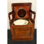 A 19th century mahogany comode with hinged lid opening to reveal open arm open seat. H.48 W.56 D.