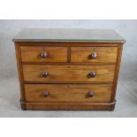 A 19th century mahogany chest of two short over two long drawers with turned handles raised on bun