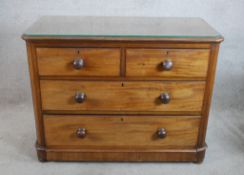 A 19th century mahogany chest of two short over two long drawers with turned handles raised on bun