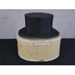 An early 20th century boxed gentlemen's black silk top hat. H.17 W.34 D.27cm