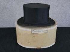 An early 20th century boxed gentlemen's black silk top hat. H.17 W.34 D.27cm