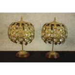 A 20th century matched pair of brass and glass table lamps, the central column support raised on