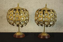 A 20th century matched pair of brass and glass table lamps, the central column support raised on