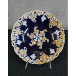 A 19th century Meissen porcelain shallow dish, the bowl painted with cobalt blue with white and gold