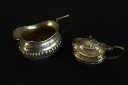 An Edward VII hallmarked silver cream jug with, Birmingham 1906, 86g gross weight, together with a