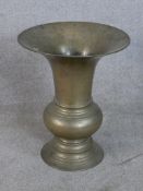 A 19th century Chinese brass vase/spitoon with flared rim raised on turned circular foot. H.50 W.