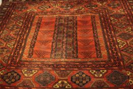 Large Persian rug. Geometric design on a burgundy field within multiple floral borders. L.350 x W.