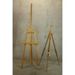 Two beech floor standing artists easels each raised on three splayed adjustable supports.