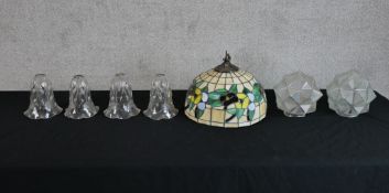 Assorted glass light shades to include a Tiffany style leaded glass light shade, a set of four