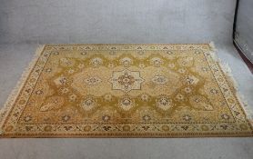 A modern Belgian woollen carpet, the central ivory field surrounded by green woollen border with