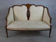 An Edwardian inlaid mahogany show framed upholstered two seater settee with pierced splat back