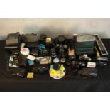 A collection of camera gear. Including Nikon SLR and Polaroid cameras. H.24 x W.23 cm. (largest).