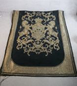 A 20th century gold thread coat of arms embroidered on a black velvet banner. H.190 W.164cm