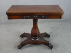 A William IV mahogany foldover card table with central faceted octagonal column support raised on