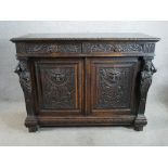 A Jacobean style S. Goff & Son carved oak sideboard, with two short doors and two cupboard doors