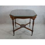 An Edwardian mahogany octagonal centre table raised on 'X' stretcher and turned supports termating