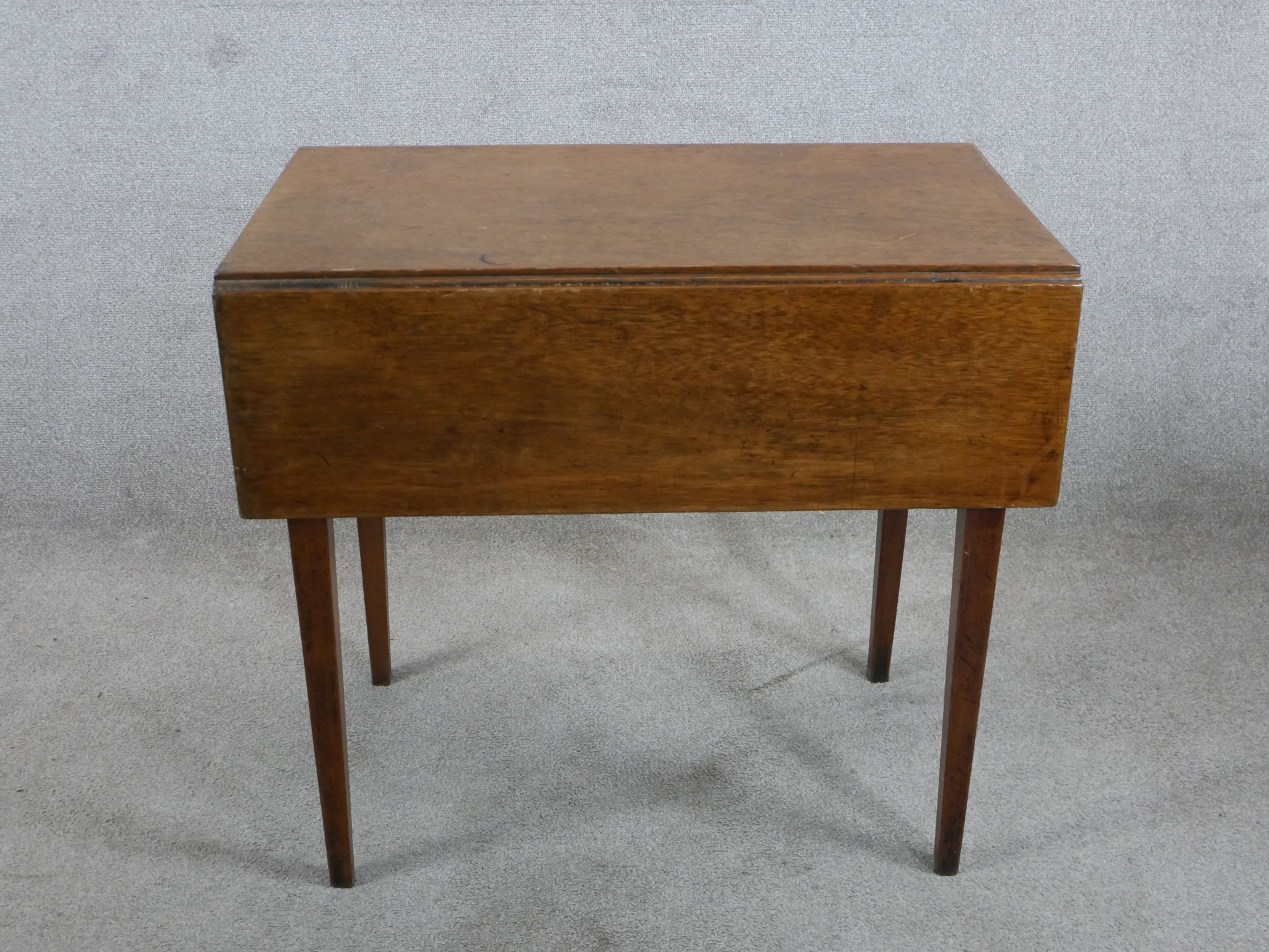 A 19th century mahogany Pembroke table, the single drawer with turned handles raised on square