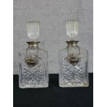 A pair of hallmarked silver collared glass decanters and stoppers together with two hallmarked