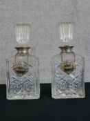 A pair of hallmarked silver collared glass decanters and stoppers together with two hallmarked