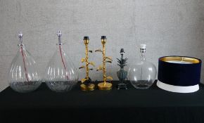 A pair of modern clear globular glass table lamps together with a pair gilt brass table lamps and