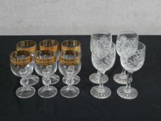 A set of six 20th century gold rimmed drinking glasses, the central knop stem raised on faceted