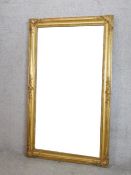 A large gilt framed rectangular wall mirror. H.155 W.90cm