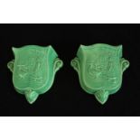 A pair of English Art Deco pottery green crackle glaze wall pockets decorated lady with geese,