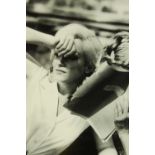 A framed black and white photograph of Marilyn Monroe partially covering her face. H.61 W.47cm.