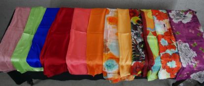 Twelve assorted vintage patterned and plain silk scarves.
