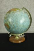 A 1970s lamp formed as a table top globe raised on circular base. H.40cm.