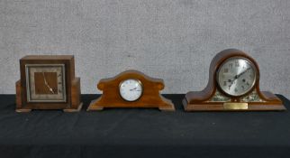 An Art Deco walnut veneered mantle square shaped mantle clock, the silvered dial with black Roman