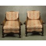 A pair of Georgian style carved beech framed and bergere arm chairs raised on carved cabriole