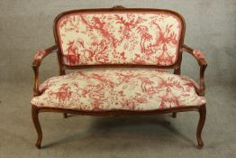 A 19th/early 20th century French style mahogany show framed upholstered open arm settee raised on