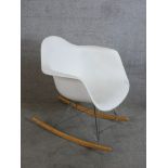 A vintage Vitra Eames RAR rocking chair with white polypropylene seats raised on wirework struts and