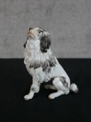 A late 19th/early 20th century Meissen porcelain model of a seated dog, impressed and painted