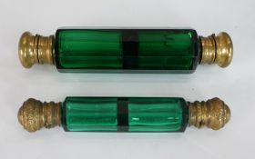 Two 19th century emerald glass and brass double ended scent bottles. H.13 W.3 D.3cm largest