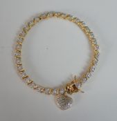 A boxed gold plated silver line bracelet with heart charm, secure hidden push clasp with safety