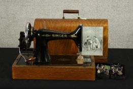 A 20th century mahogany cased manual sewing machine. H.33 W.43 D.20cm.