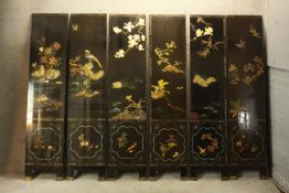 A late 19th/early 20th century Japanese lacquer six panel five fold floor standing screen