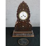 A 19th century carved Indian hardwood and inlaid mother of pearl mantle clock, the white dial with