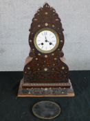 A 19th century carved Indian hardwood and inlaid mother of pearl mantle clock, the white dial with