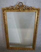 A 19th century gilt painted rectangular wall mirror with applied bow decoration. H.147 W.95cm