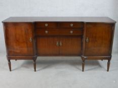 A 20th century Strongbow mahogany inverted breakfront sideboard with two short over single long