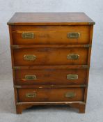 A Georgian style yew veneered campaign style chest of four drawers raised on shaped bracket feet.