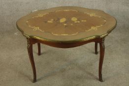 A 20th century Italian style inlaid coffee table raised on carved cabriole supports raised on carved