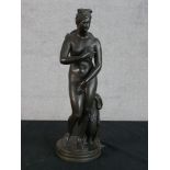 A 20th century cast brass figure of Venus de Medici raised on naturalistic base. H.34 W.11 D.11cm